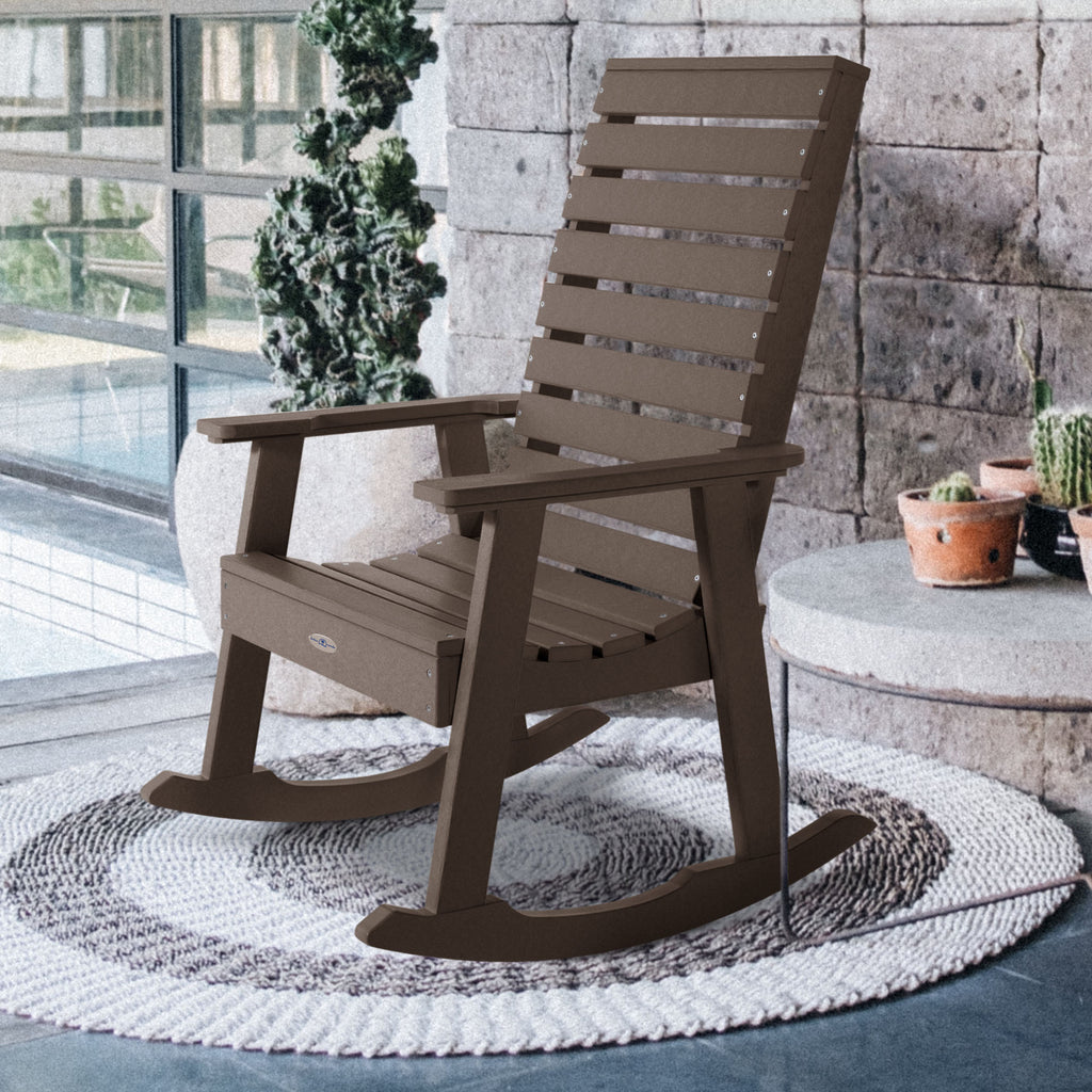 Brown Riverside rocking chair on front porch with circle rug