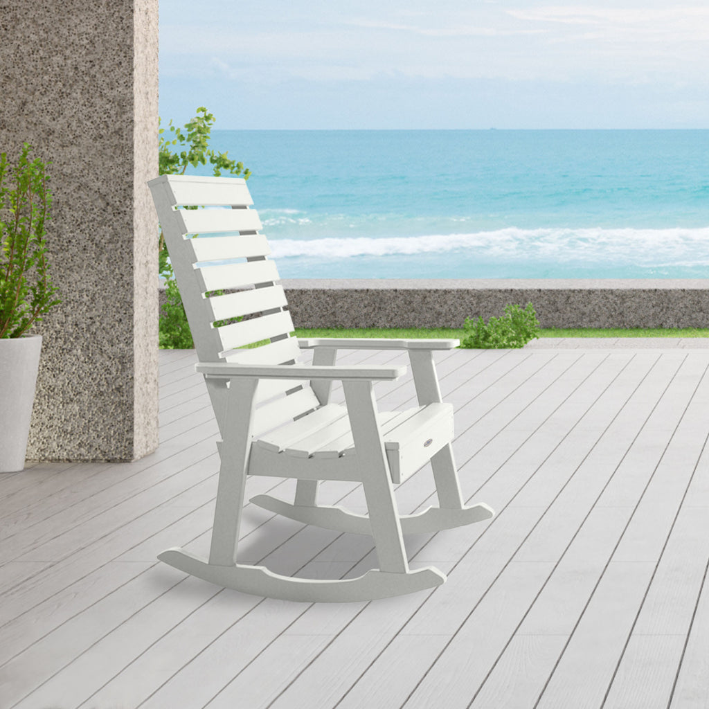 White Riverside rocking chair on patio with ocean in background