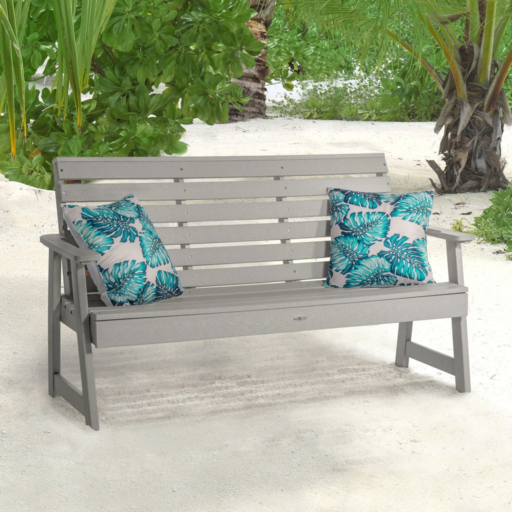 Gray Riverside Garden bench on beach with pillows 