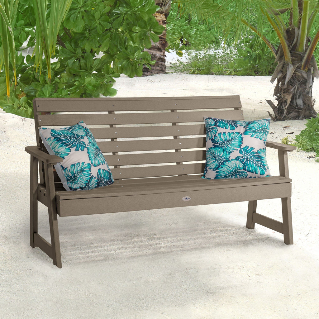 Tan Riverside Garden bench on beach with pillows 