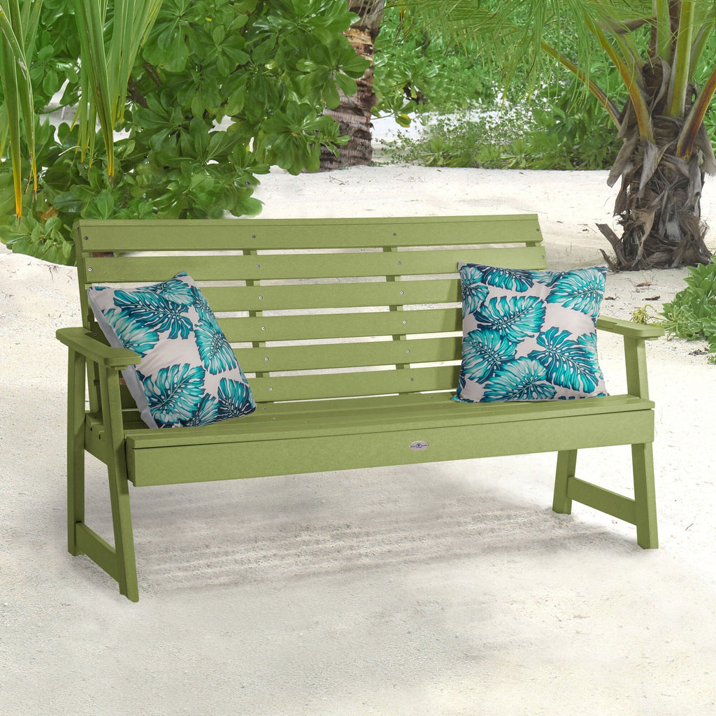 Green Riverside Garden bench on beach with pillows 
