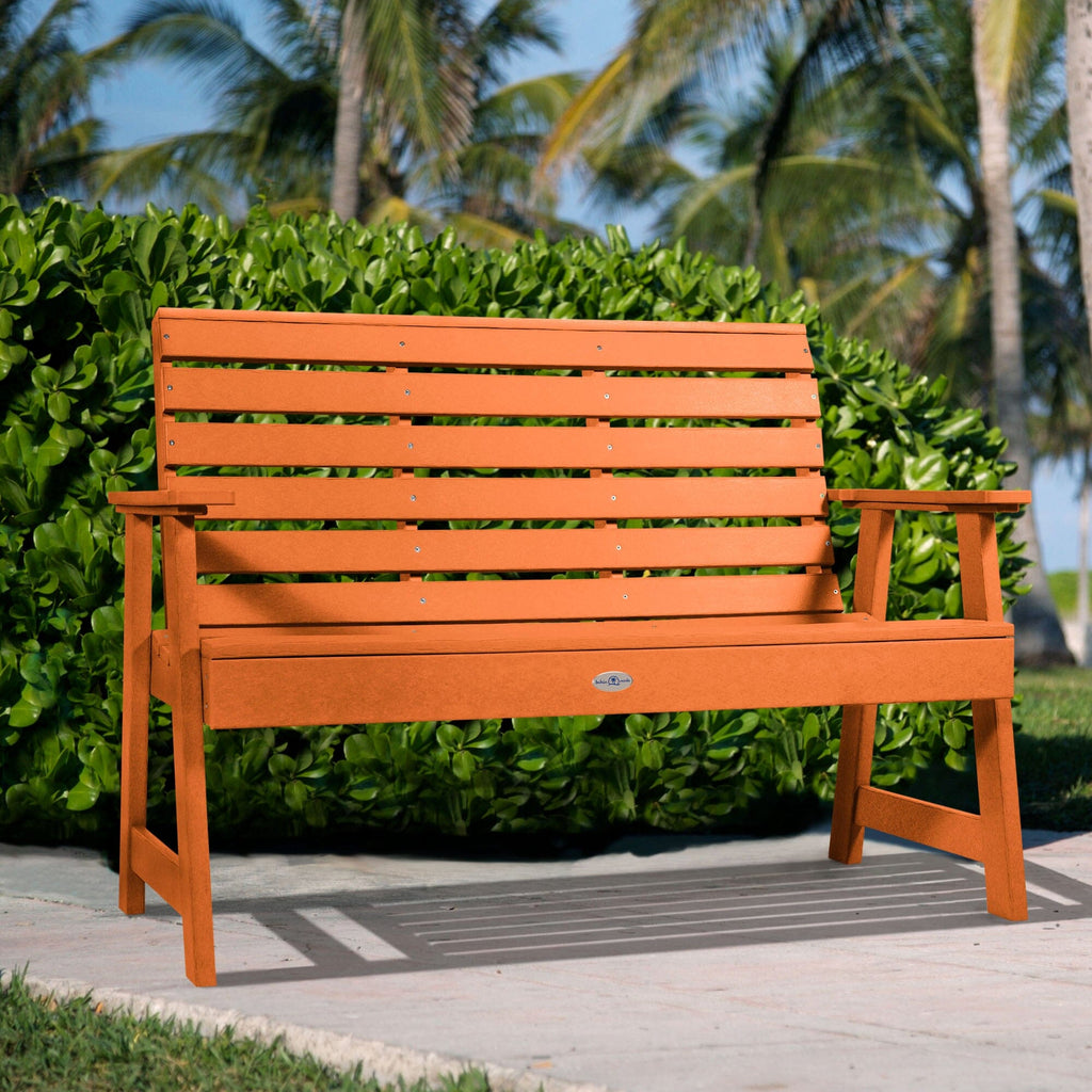 4ft Orange Riverside garden bench with palm tree and bush background   