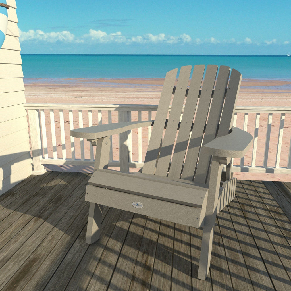 Gray Cape folding Adirondack chair on a deck overlooking the beach