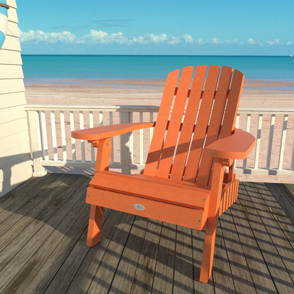 Orange Cape folding Adirondack chair on a deck overlooking the beach