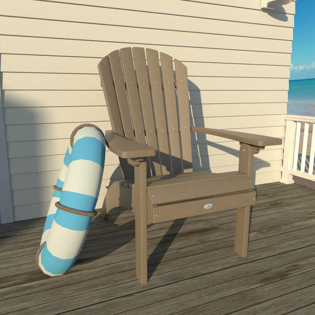 Tan Waterfall comfort height Adirondack chair on a deck with a life ring