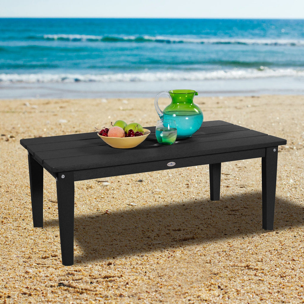 Black Adirondack Conversation table on a beach