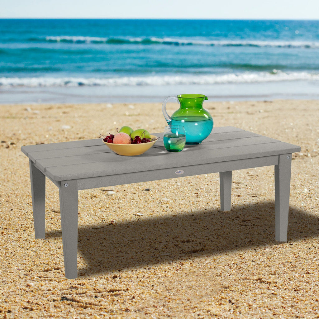 Gray Adirondack Conversation table on a beach