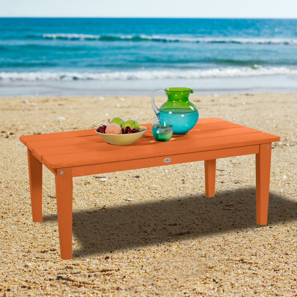 Orange Adirondack Conversation table on a beach
