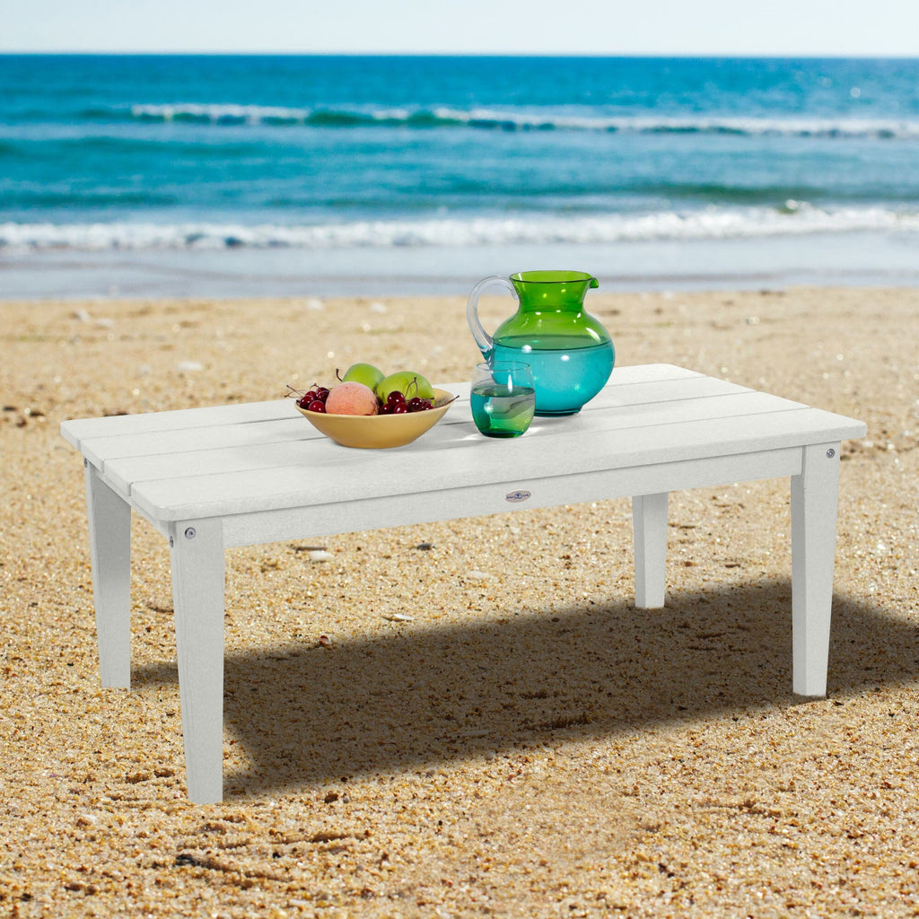 White Adirondack Conversation table on a beach
