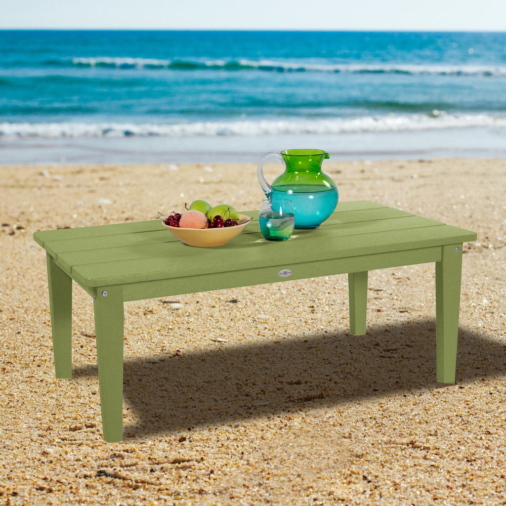 Green Adirondack Conversation table on a beach