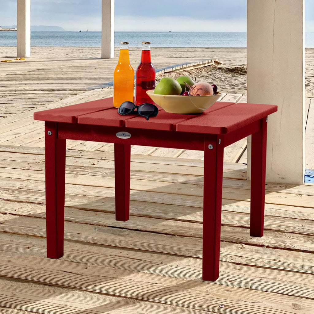 Large red Adirondack side table with drinks, fruit, and sunglasses