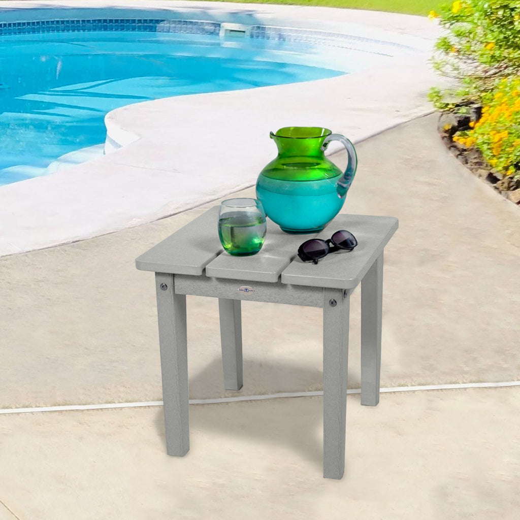 Small Gray side table with water pitcher and sunglasses