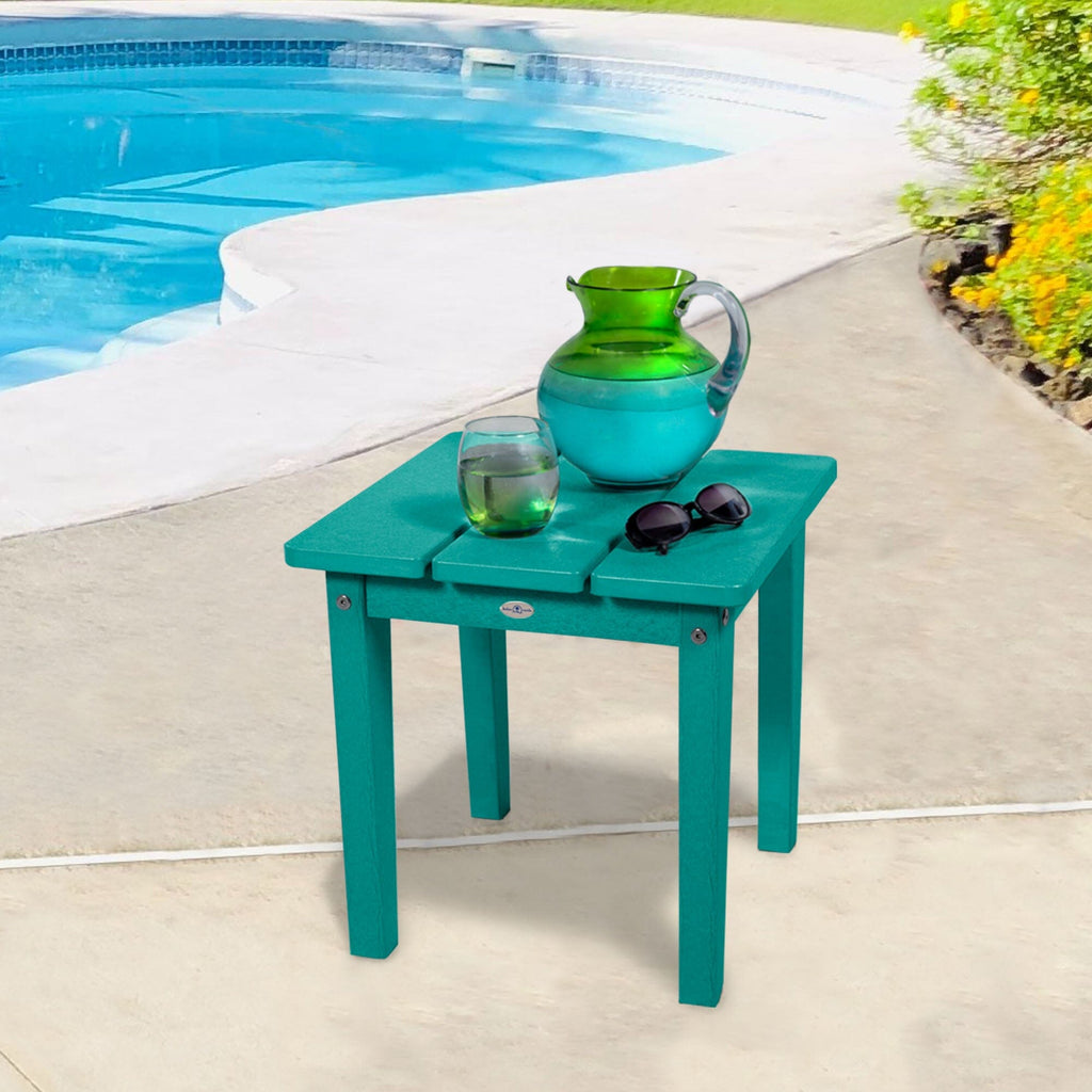 Small blue side table with water pitcher and sunglasses 
