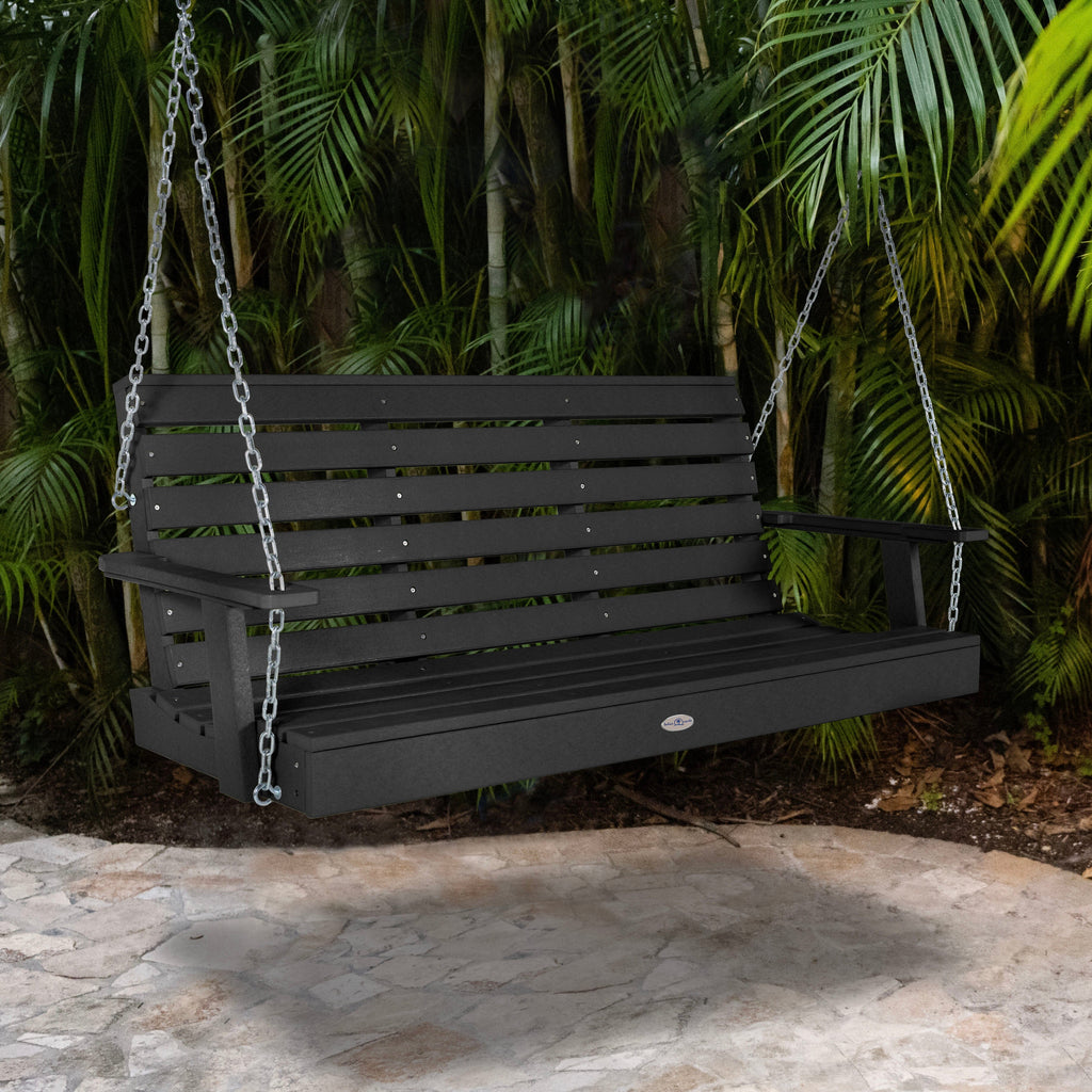 Black Sand porch swing with palm background