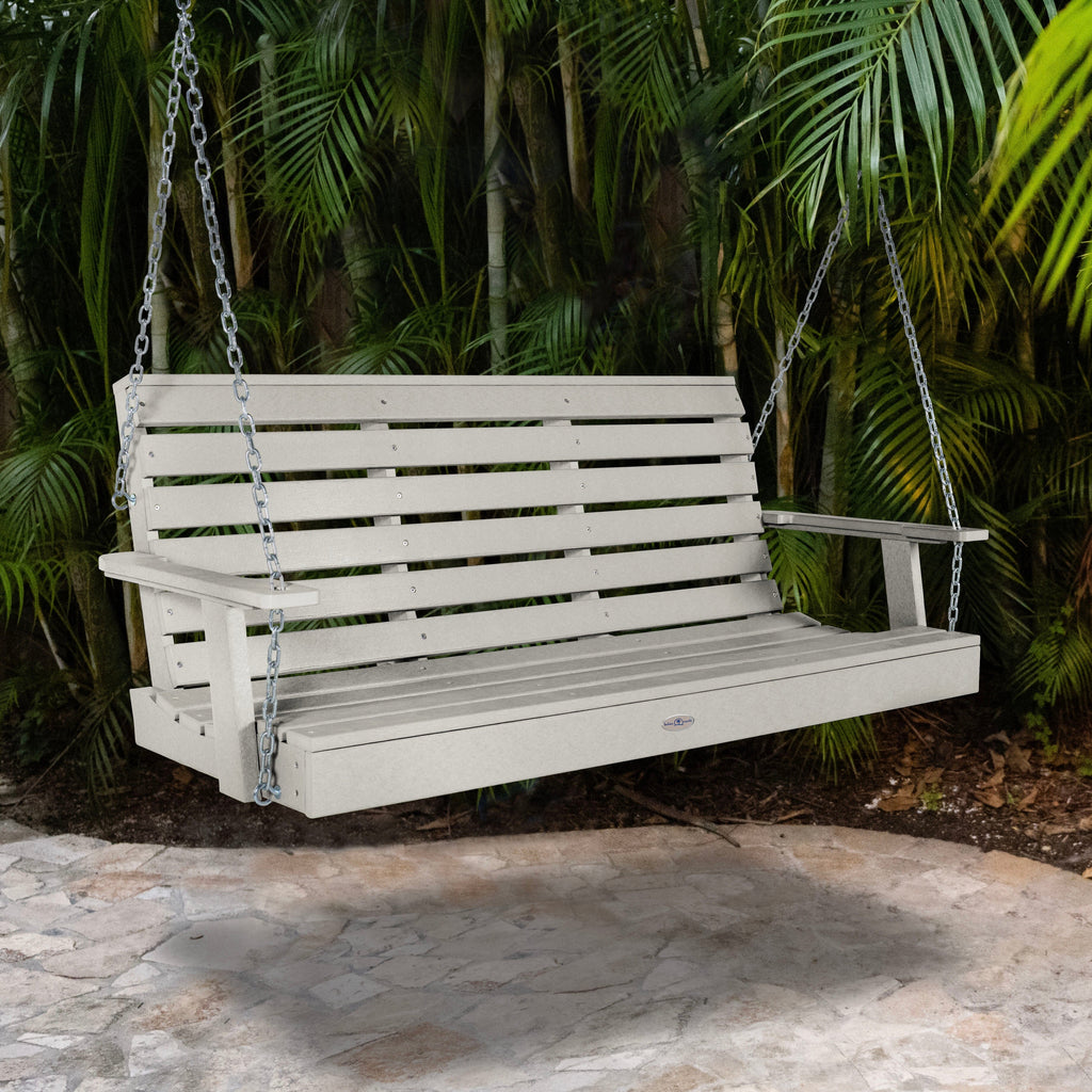 Cove gray porch swing with palm background