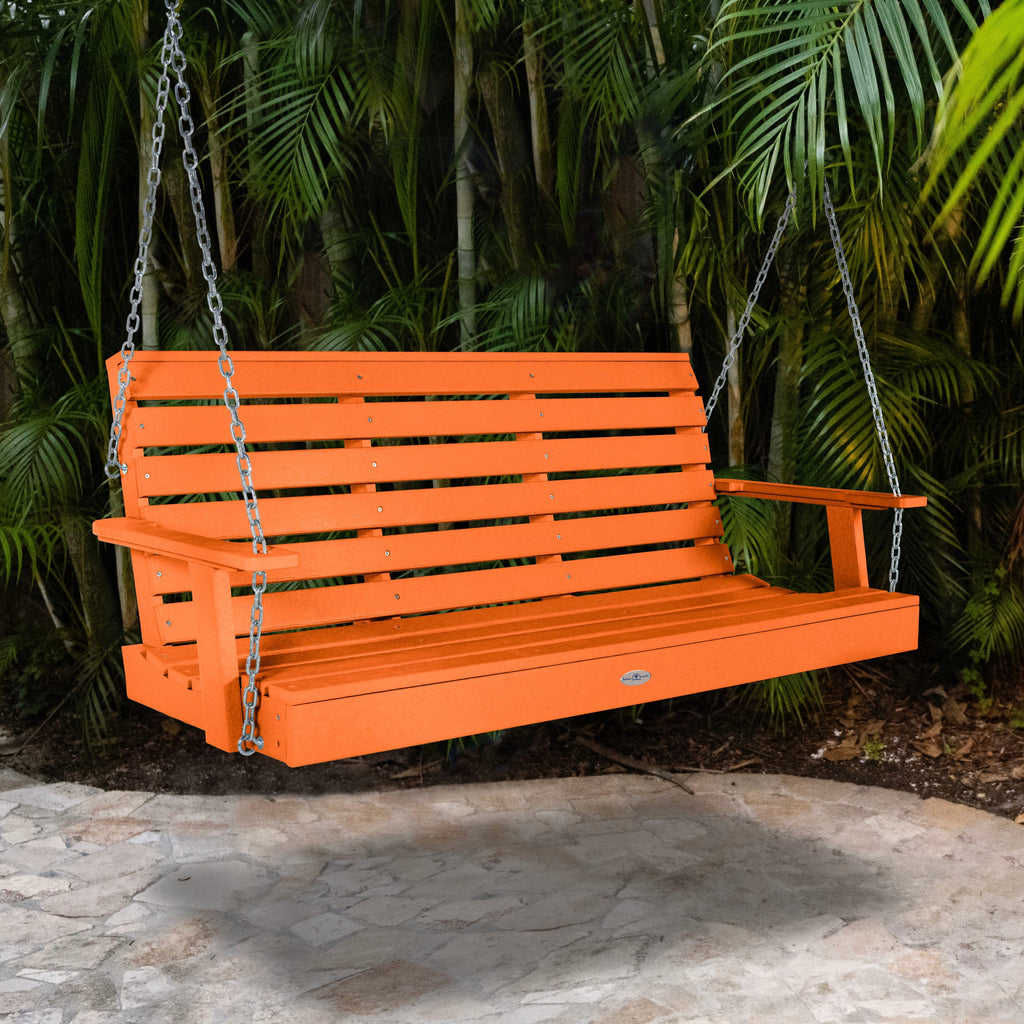 Orange porch swing with palm background